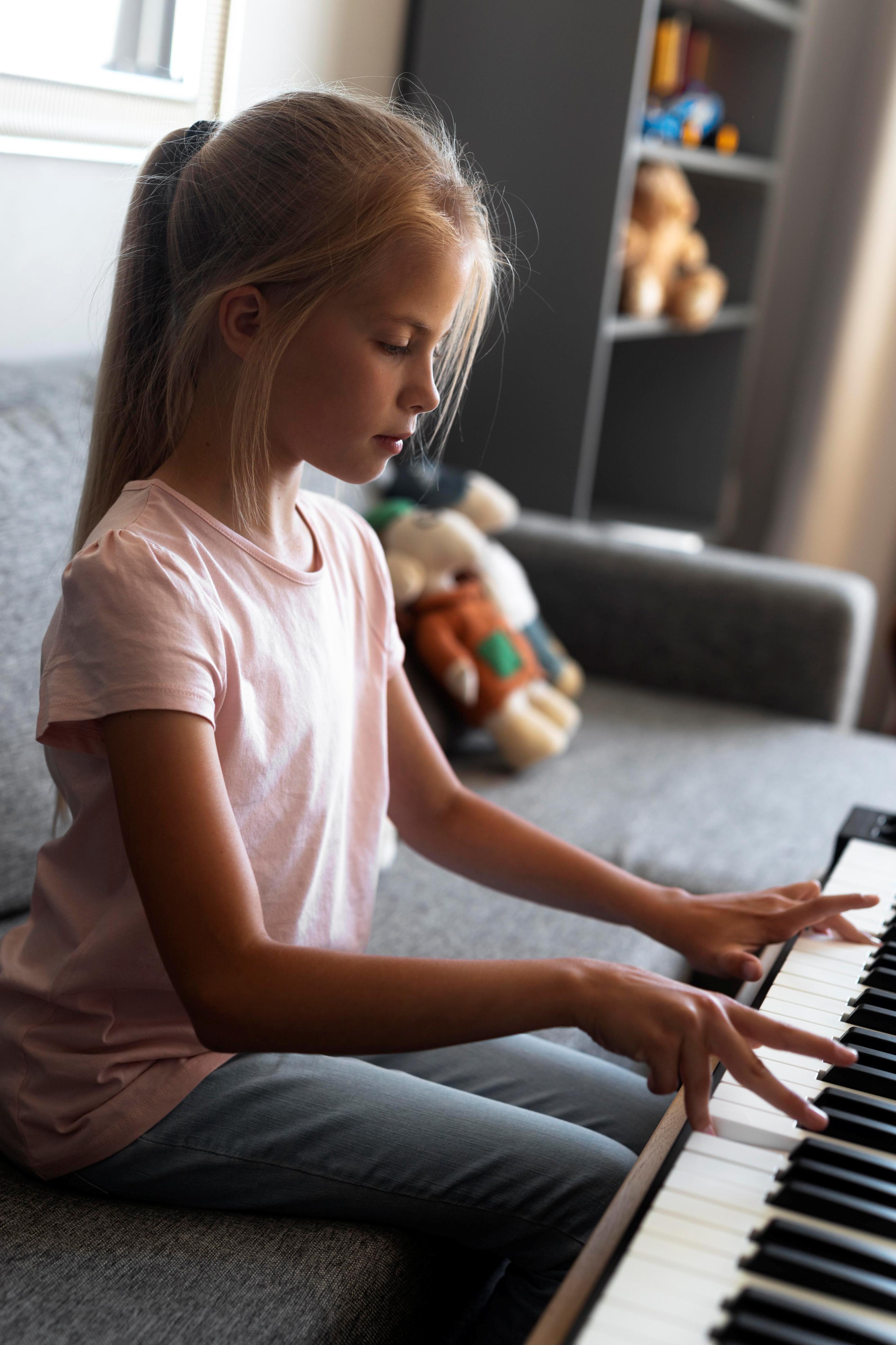 little girl playing keyboard home